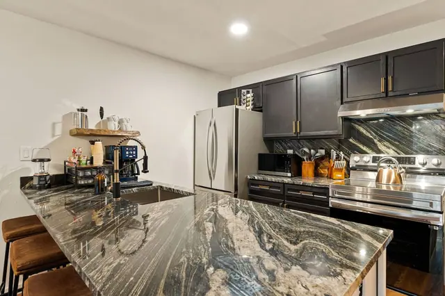 Pull an espresso from the built-in station, fill a pot straight from the faucet over the range, and cook a real breakfast before you head for the lift this kitchen was stocked to be used, not just photographed.