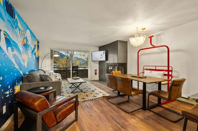 Claim the armchair by the window, flip on the TV, and let the fire crackle behind you this corner somehow fits the whole group without anyone fighting for space.