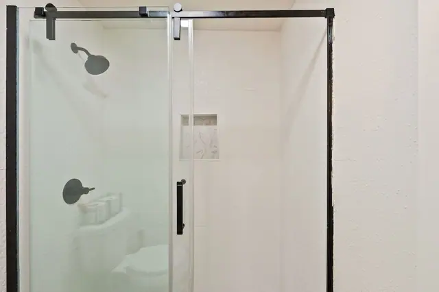 Set your shampoo on the built-in shelf and rinse the cold off in the walk-in shower no shower curtain sticking to your legs on this trip.