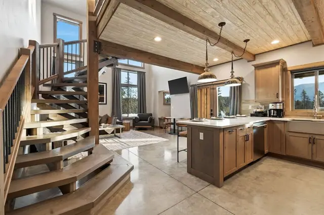 Walk in and look up the spiral staircase and soaring ceilings pull the whole main floor into one big room, the kind where your whole group ends up together.