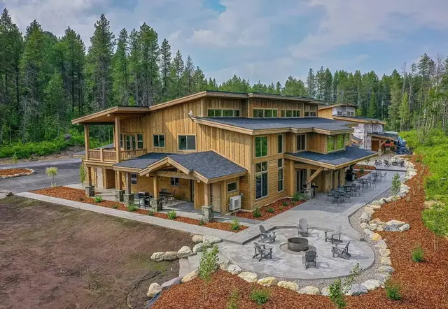 Picture this as your home base for Glacier tucked into the pines, fire-pit patio right out front, four minutes from the park entrance.