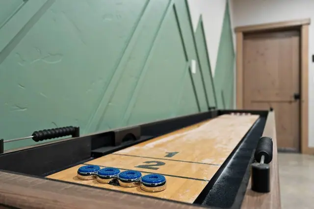 Slide the puck and call your shot shuffleboard's the game that gets even the quiet ones talking trash by round two.