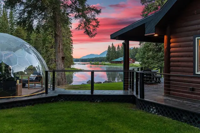 Watch the sky turn pink over the lake while your geodome and cabin windows glow warm in the dusk.