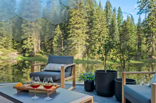 Pour yourself a glass of wine and settle into the geodome's cushioned lounge, pond and forest glowing just beyond the glass.