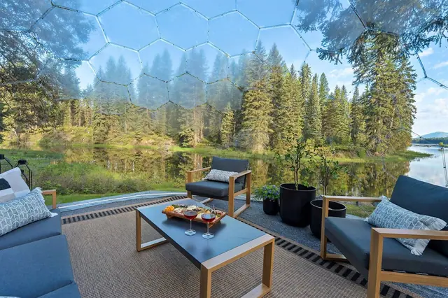 Lean back in the geodome lounge with wine in hand as forest and pond blur softly through the mesh dome around you.