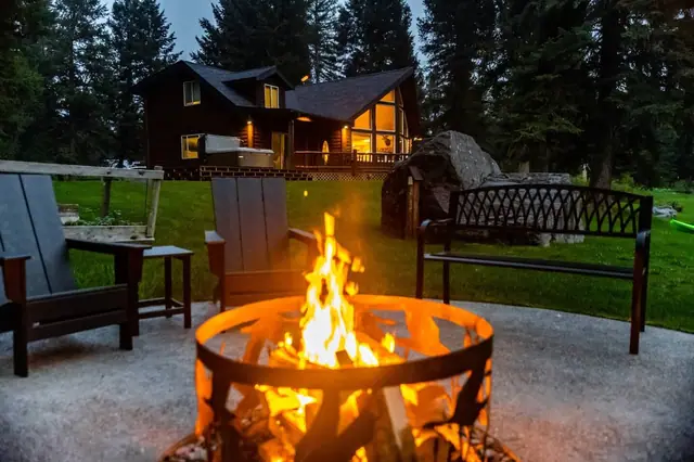 Pull up an Adirondack chair to the crackling fire pit while the cabin glows warmly across the lawn behind you.