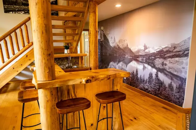 Pull up a leather stool at the live-edge log bar under the mountain mural for your nightcap before bed.