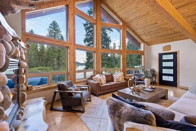Sink into the leather sofa and let the floor-to-ceiling windows frame the pines and lake for you.