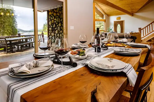 Walk in past the stacked-stone pillar and mountain mural, your dining table and staircase come into view right away.