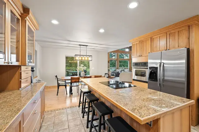 Cook and gather at your island while pendant lights and forest views through the windows set the scene.