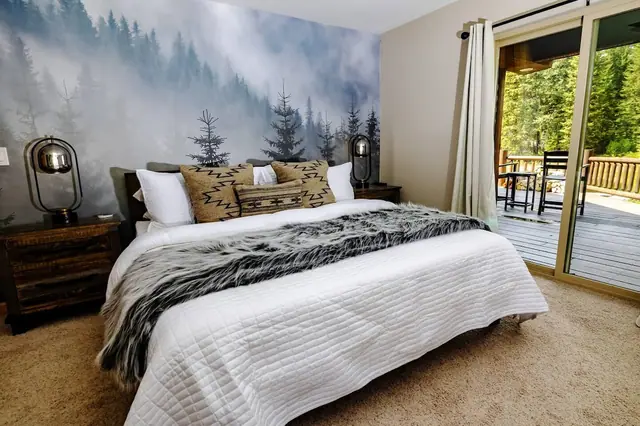 Slide open the glass door straight from your headboard's mountain-forest mural to the deck seating just outside.