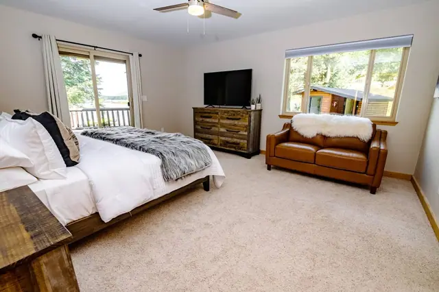 Curl up on the tan leather loveseat with a movie on and pond views right outside your primary suite windows.