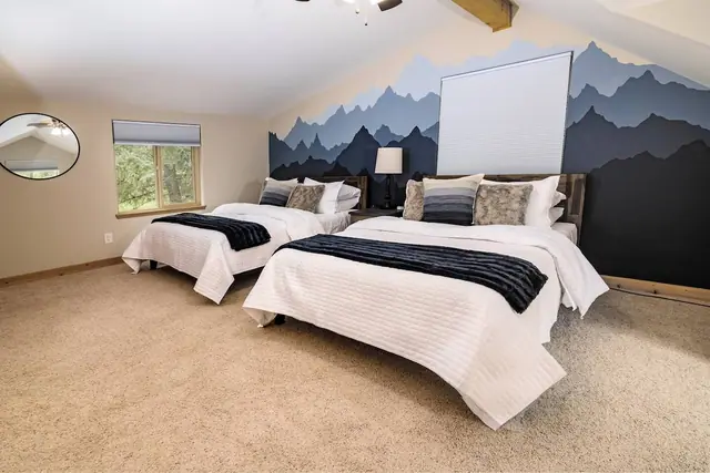 Settle the kids into two queen beds beneath a mountain silhouette mural in your upstairs second bedroom.