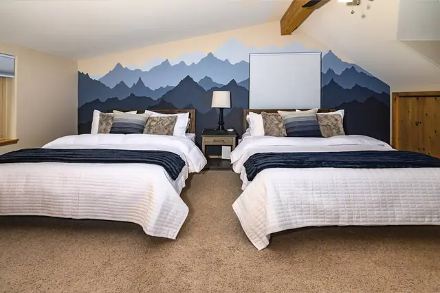 Rest under exposed wood beams in either of the two queens, mountain silhouettes painted right behind your headboard.
