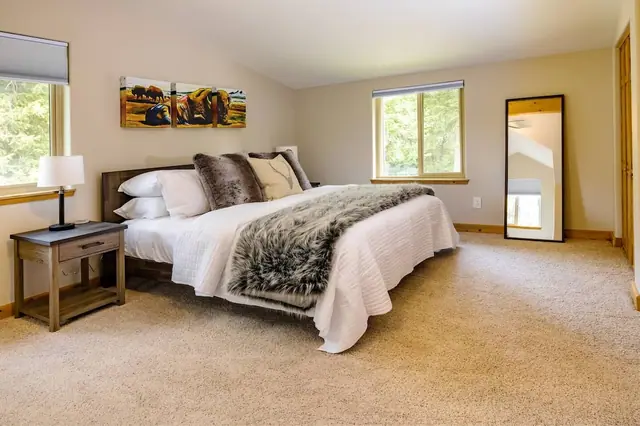 Get yourself ready for the day in front of the tall floor mirror before climbing into the fur-throw-covered king bed.