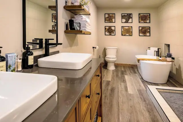 Wash up at dual vessel sinks or soak in the freestanding tub, your master bath does both in style.