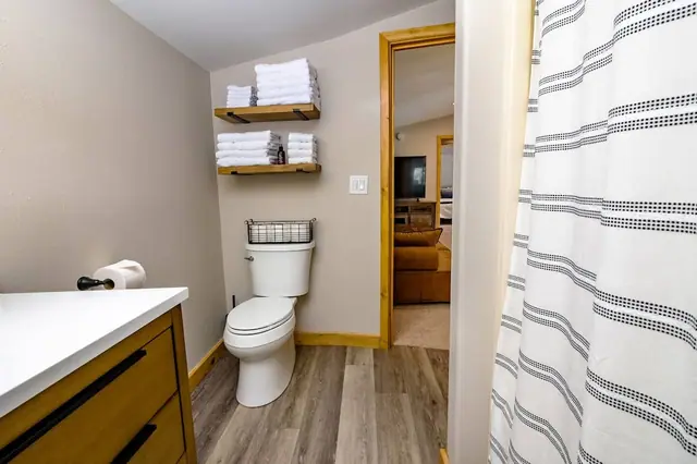 Grab a fresh towel from the floating shelves before you step into the shower just off the bedroom.