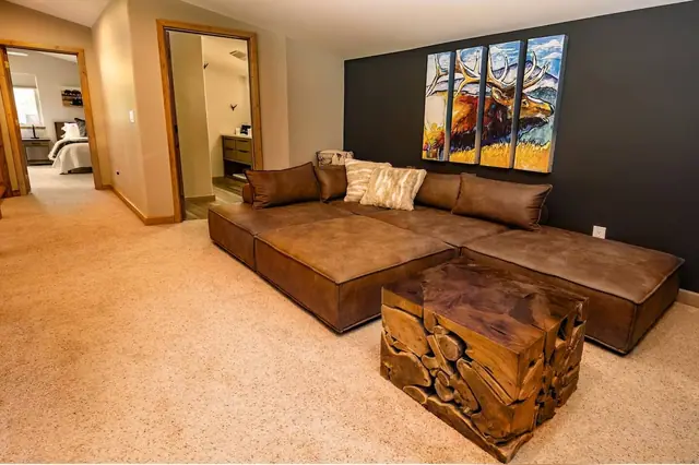 Kick your feet up on the live-edge ottoman in the bonus lounge, bedrooms and bath just down the hall.