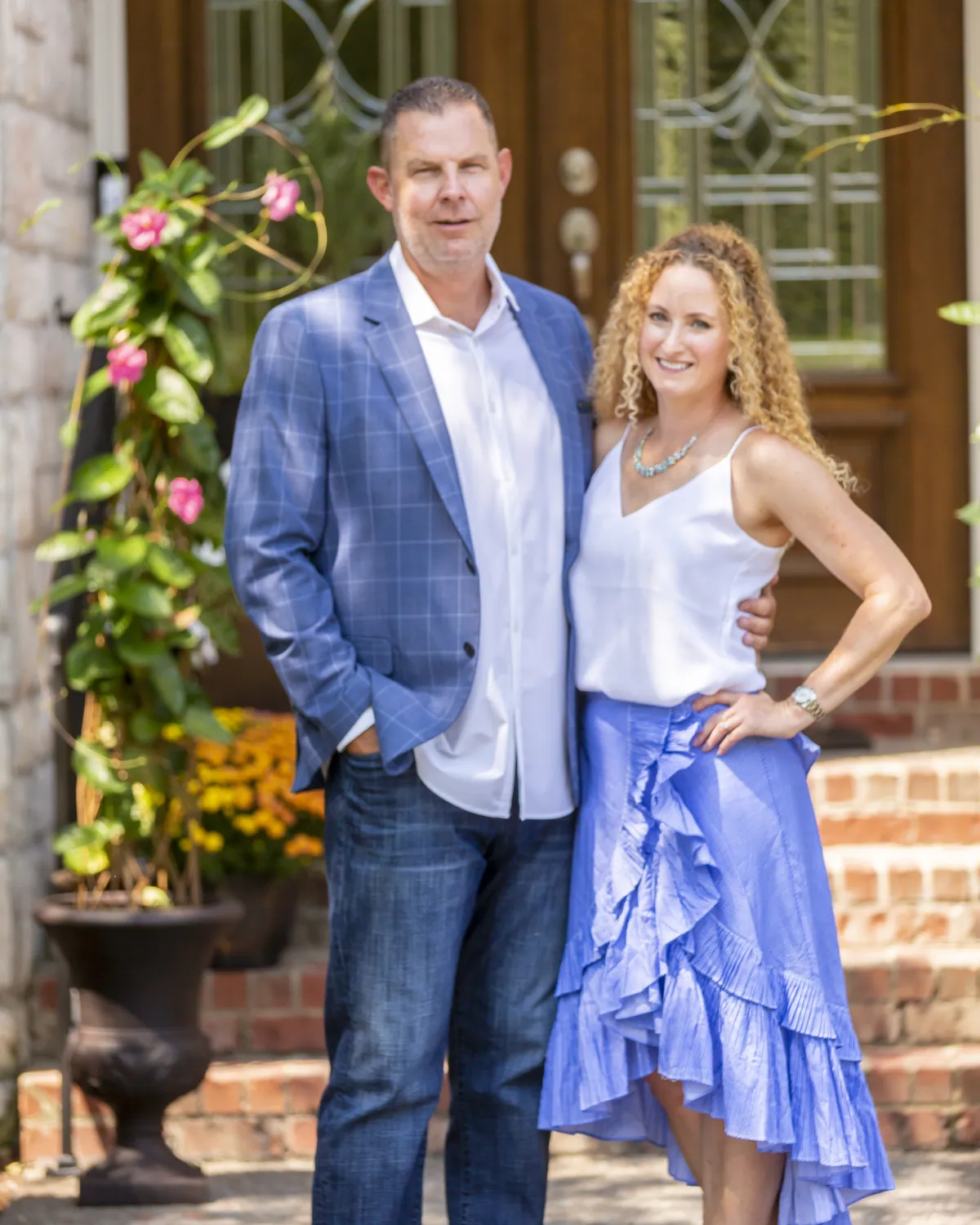 Bill and Brea Faeth, the owners of Ultara Stays, at the front door of the lodge