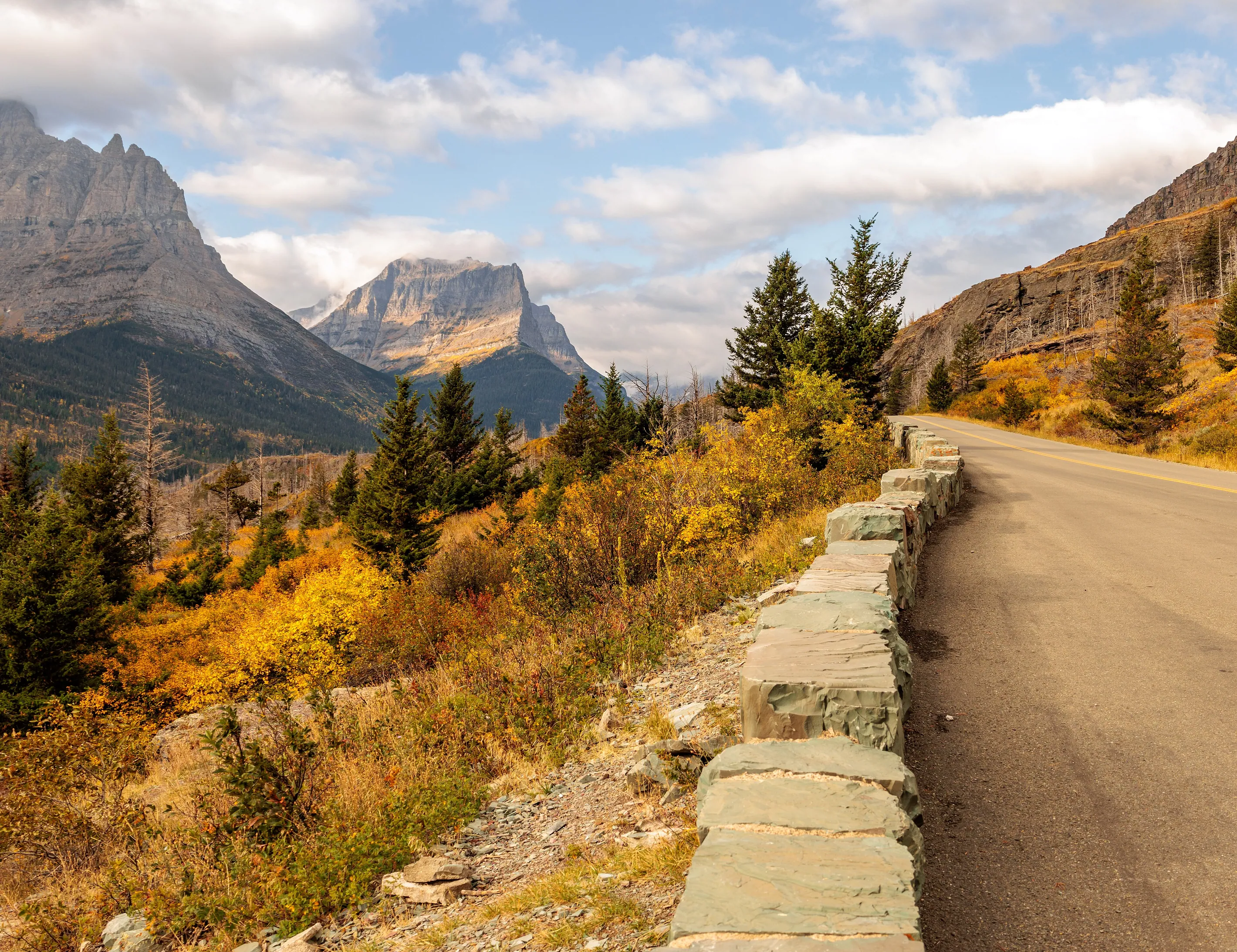 Going-to-the-Sun Road in autumn, its stone wall following the mountainside