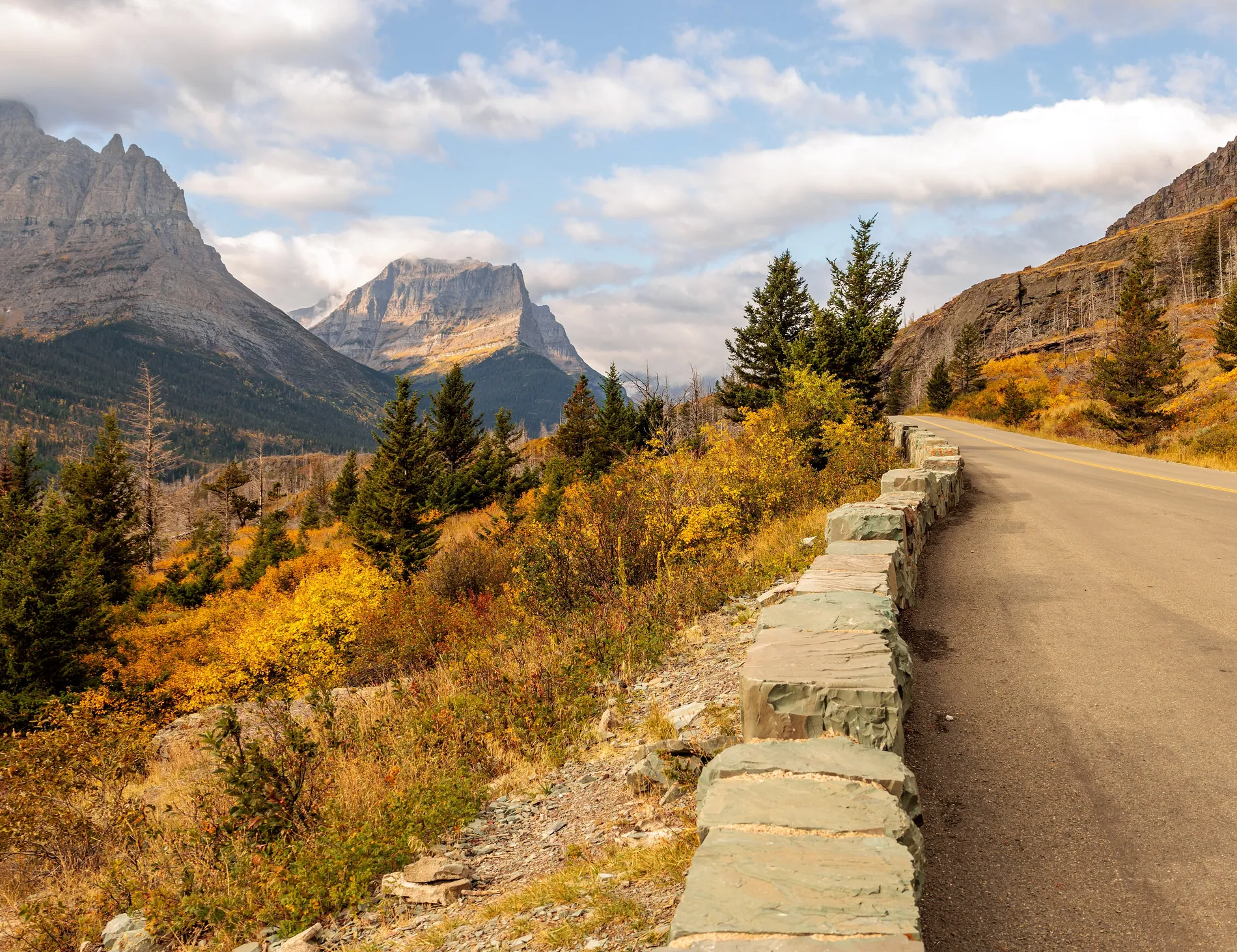 Going-to-the-Sun Road in autumn, its stone wall following the mountainside