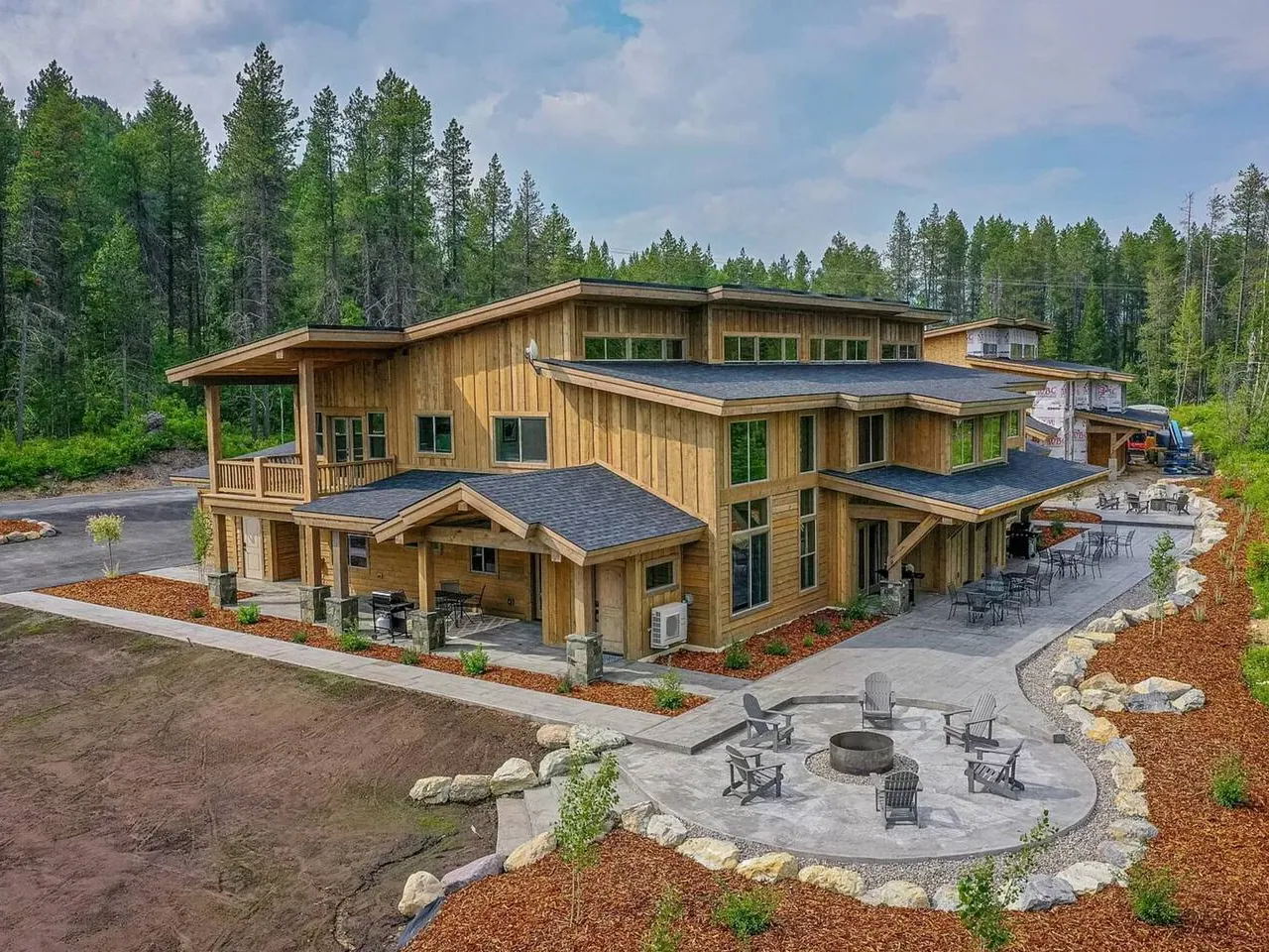 Glacier Getaway from the air in summer, the townhouse and its neighbours among the pines