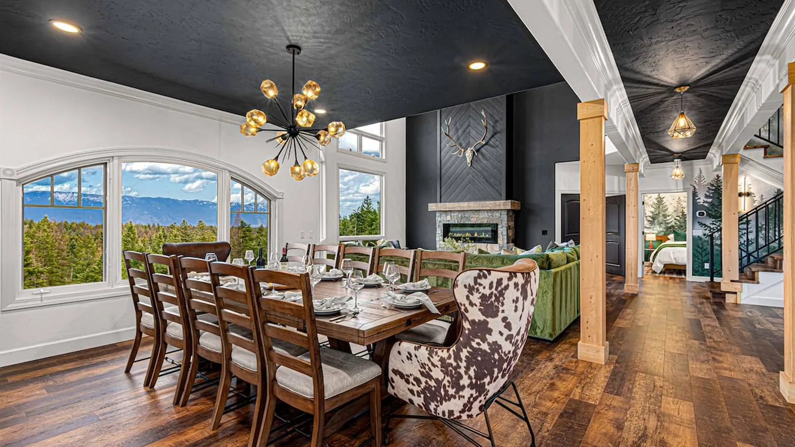 A dining room photographed with intent, the range framed through the window