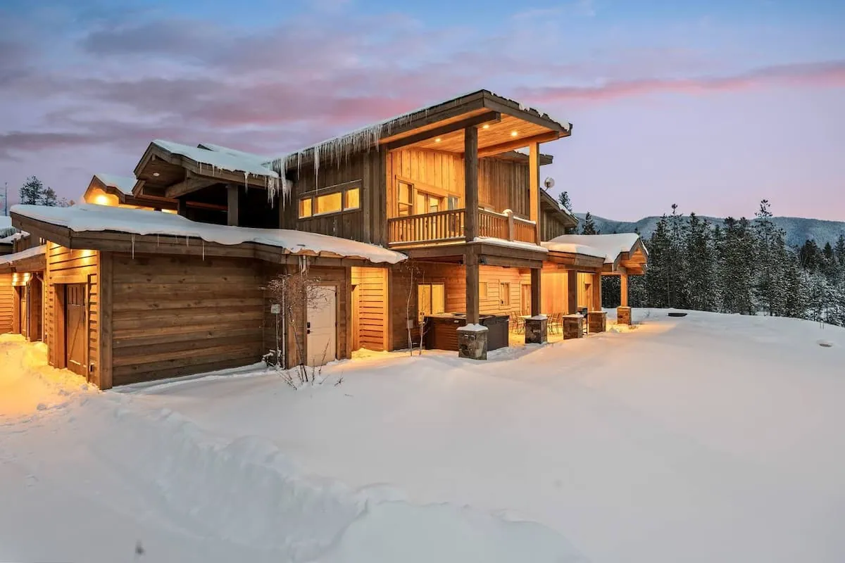 Glacier Getaway after sunset, icicles along the eaves catching the last pink light off the snow