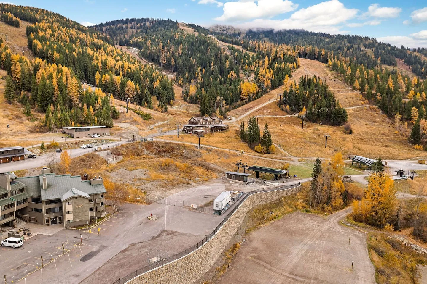 Whitefish Mountain Resort from above, the lift line tracing up the slope with the village at its foot
