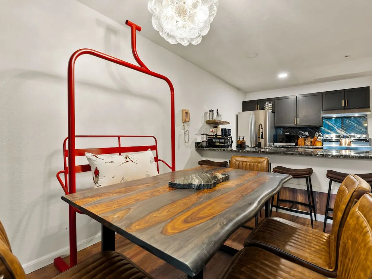 A retired red chairlift bench pulled up to the dinner table at Chasing Powder