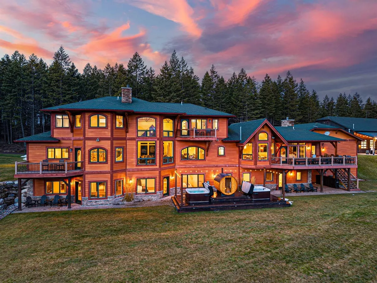 Soaring Eagle at dusk, the whole lodge lit from within above the lawn
