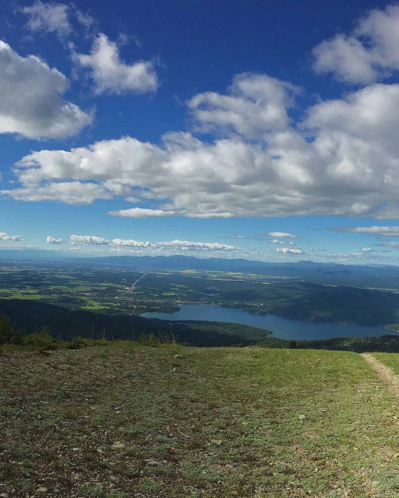 Whitefish Lake and the town below it, seen from the top of Big Mountain on a June morning
