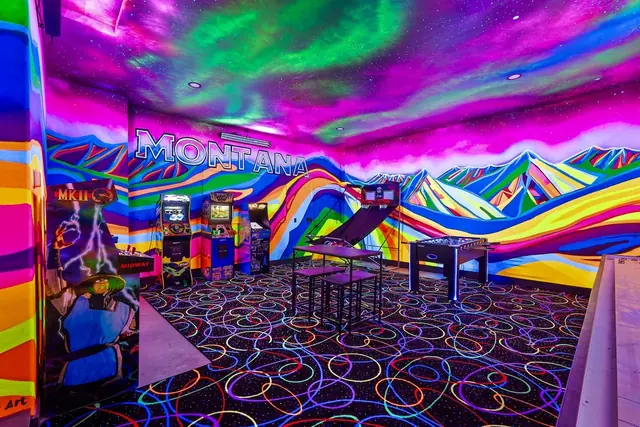 Duck into the neon-lit arcade room, where a floor-to-ceiling MONTANA mural and a glow-in-the-dark floor light up your game night.