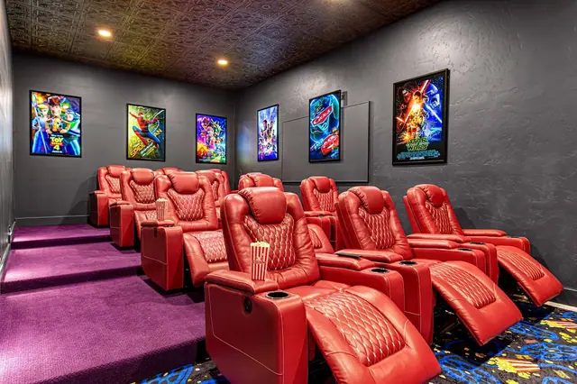 Claim a reclining seat in your private theater and watch the illuminated poster wall dim as the show starts.