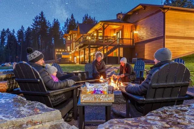 Roast marshmallows with your crew at the s'mores station under a starry sky while the lodge glows behind you.