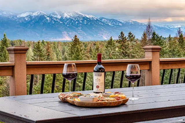 Pour two glasses and lay out the charcuterie board on the railing while the peaks fill the view behind you.