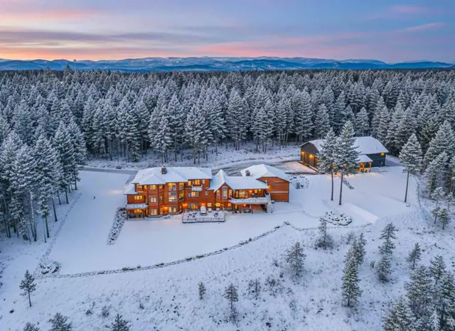 Walk your wraparound deck beneath the timber gables for a panoramic sweep of snow-capped peaks and pine forest.