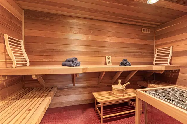 Climb up to the top bench in the wood-paneled sauna and ladle water over the stones to build your heat.