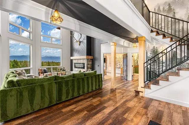 Stretch out under the vaulted ceiling while the stone fireplace and mounted antlers anchor your great room below the staircase.