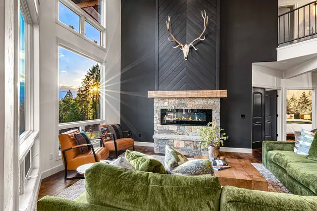 Warm up by the stone fireplace while the antler mount watches over your evening from the mantel.