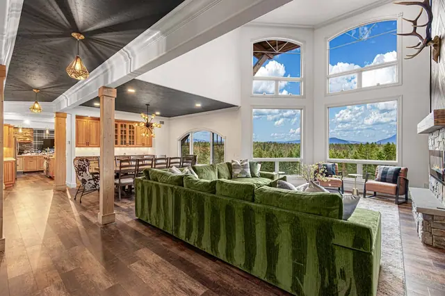 Move freely between the kitchen, dining table, and sectional in your open great room under mountain-view windows.