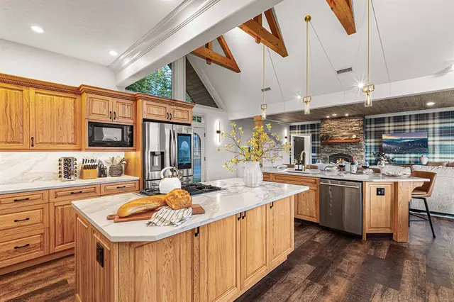 Cook from every angle of the island while pendant lights and the accent wall set the scene for your dining table beyond.