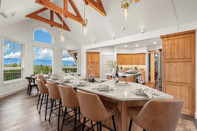 Pull up a barstool at the island while your mountain view stretches out past the dining table.