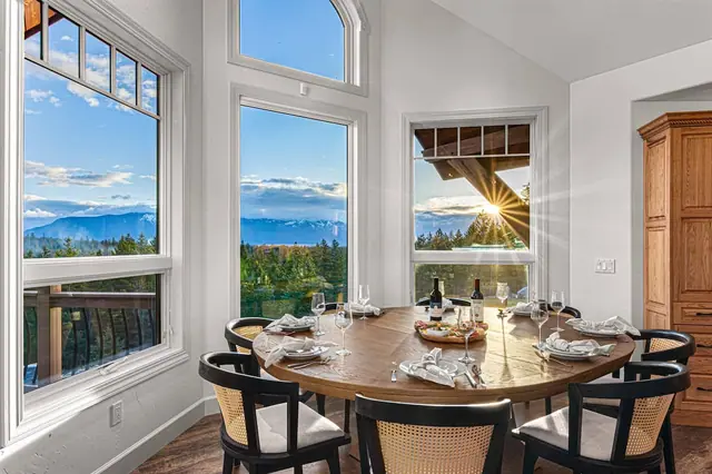Gather six around the round table as sunlight flares through the arched windows over your mountain view.