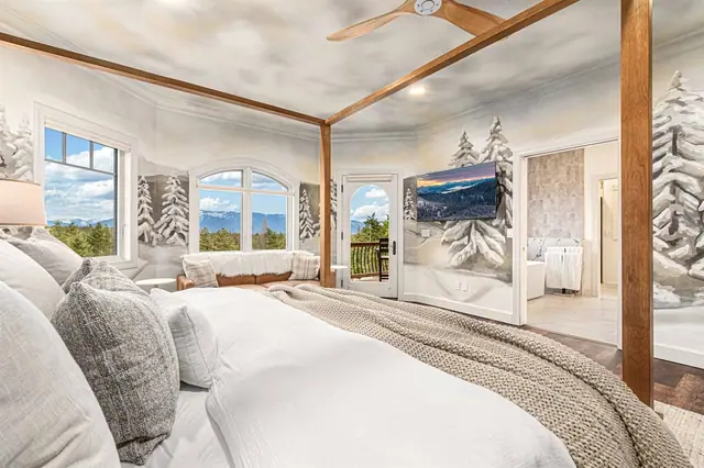 Curl up in the window seat nook of the primary suite while the ensuite bath waits through the open door.