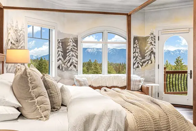 Wake up under the canopy frame with snow-capped peaks visible right through your balcony door beside the bed.