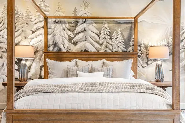 Sink into a stack of pillows at the canopy headboard, the mural forest stretching out behind you.