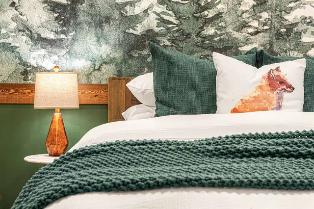 Switch on the amber nightstand lamp and pull the knit throw over you as the fox pillow keeps watch.
