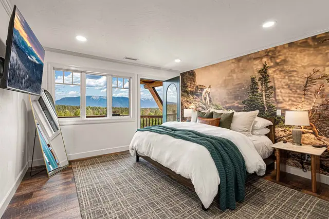 Lean your skis by the window and crash on the bed backed by a canyon mural after a day on the mountain.