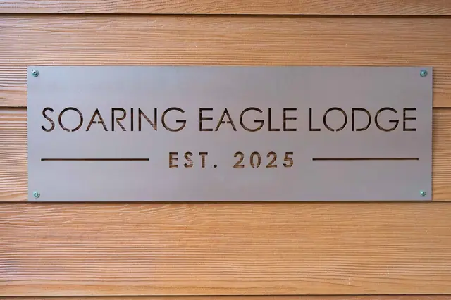 Spot the Soaring Eagle Lodge plaque mounted by the entrance, marking the house you've booked.